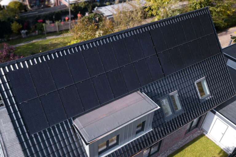 Black panels powering a home with a heatpump and with lithium battery storage